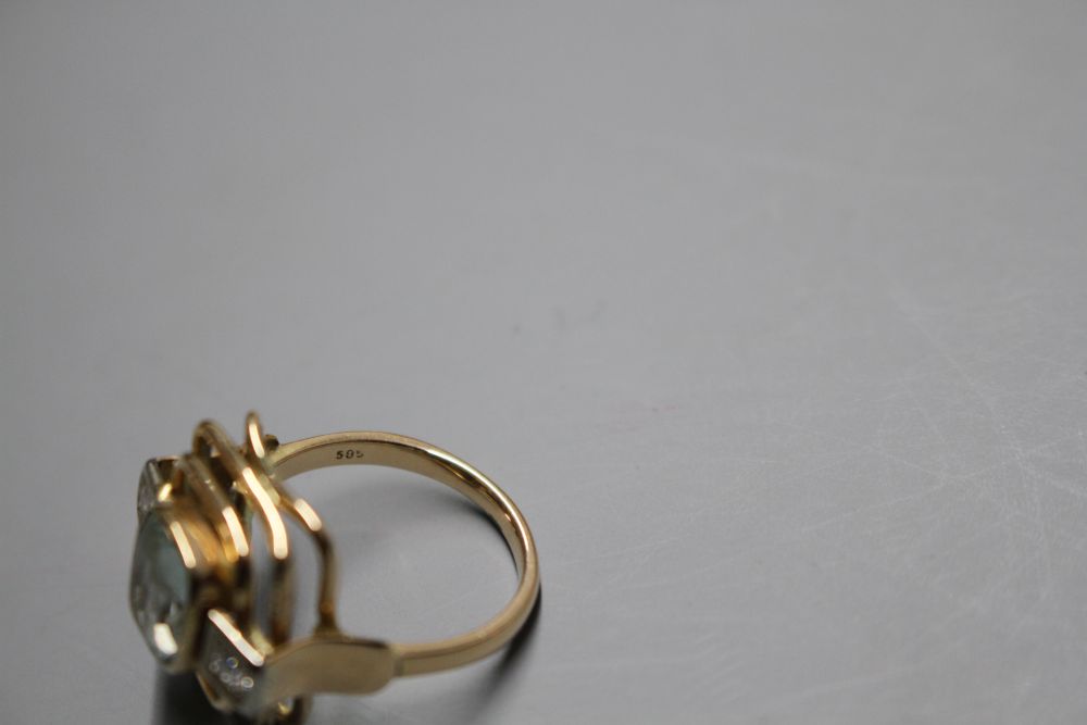 A 585 yellow metal, aquamarine and diamond set three stone dress ring, with pierced stepped setting,